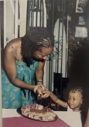 Izora Devonish, aged two-and-a-half, helps mum Linda cut the cake at ArtsEtc's launch party at the Waterfront Café, Bridgetown, in 2004