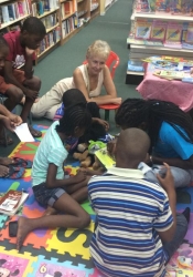 Writers Sarah Venable and DJ Simmons with young storytellers at Days Books, Bridgetown for the launch of ArtsEtc's Read2Me!-Write4Me! programme in 2015