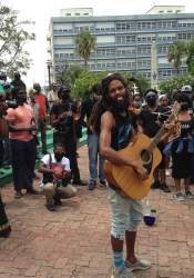 Barbadian musician Khalid "AquaFari" Batson playing guitar during protests to take down the statue of Lord Nelson in Bridgetown, June 2020.