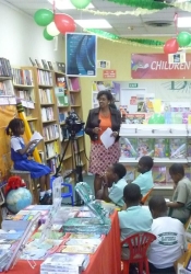 Karen with young participants during a live broadcast from the store World Book Day