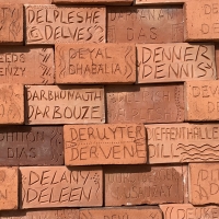 Terracotta tile featuring the name Deane among other tiles with surnames also starting with the letter D on the Wall of Names, Golden Square Freedom Park, Bridgetown, Barbados. Photo by LM Deane