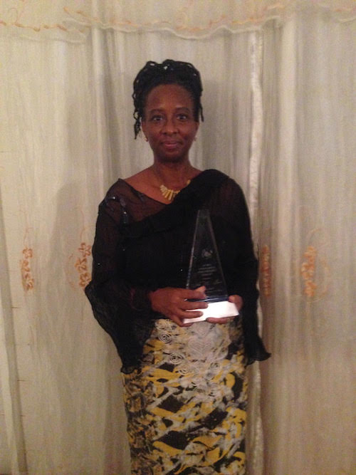 ArtsEtc Editor Linda M. Deane holding her 2017 Barbados Governor General's Award of Excellence in Literary Arts.