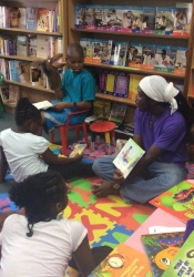 Dempstu Simmons Jr (Uncle DJ) reading to children in Days Bookstore, Bridgetown, Barbados as part of ArtsEtc's Read2Me! programme.